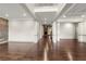 Open-concept hallway area featuring hardwood floors, stone accents, and elegant column details at 4015 Roberts Crest Ln, Suwanee, GA 30024