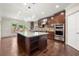 Bright kitchen featuring a large island, stainless steel appliances and dark cabinetry at 4015 Roberts Crest Ln, Suwanee, GA 30024