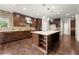 Modern kitchen boasts an oversized island, stainless steel appliances and stylish dark wood cabinetry at 4015 Roberts Crest Ln, Suwanee, GA 30024