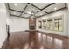 Living room boasts a stone fireplace, coffered ceilings, and large windows for ample natural light at 4015 Roberts Crest Ln, Suwanee, GA 30024