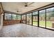 Inviting sunroom with stone floors, ceiling fans and large windows overlooking the backyard at 4015 Roberts Crest Ln, Suwanee, GA 30024