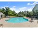 A sparkling community pool with lounge chairs, trees and greenery provide relaxing place at 4015 Roberts Crest Ln, Suwanee, GA 30024