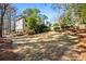 Expansive backyard featuring a spacious lawn and mature trees, perfect for outdoor activities and relaxation at 4506 Westcliff Ne Trce, Roswell, GA 30075