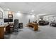 Finished basement features an office space, a seating area with a leather sofa, and neutral carpet at 4506 Westcliff Ne Trce, Roswell, GA 30075