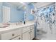 A stylish bathroom features a vanity with a white countertop and blue walls at 4506 Westcliff Ne Trce, Roswell, GA 30075