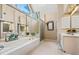 A well-lit bathroom boasts an inviting tub and shower, complimented by a vanity at 4506 Westcliff Ne Trce, Roswell, GA 30075