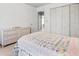 Bedroom with a colorful quilt, dresser, and view into the hallway at 4506 Westcliff Ne Trce, Roswell, GA 30075