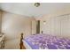 A cozy bedroom has a patterned wall, carpet and a bed with a quilt at 4506 Westcliff Ne Trce, Roswell, GA 30075