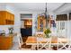 Sunlit dining area with oak cabinets and charming chandelier at 4506 Westcliff Ne Trce, Roswell, GA 30075