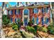 Lovely brick home featuring an arched window and blue shutters on a landscaped hill at 4506 Westcliff Ne Trce, Roswell, GA 30075