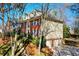 Brick home with an attached three-car garage, blue shutters, and manicured lawn at 4506 Westcliff Ne Trce, Roswell, GA 30075