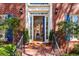 Front door view of a home with brick steps, blue shutters, and a glass storm door at 4506 Westcliff Ne Trce, Roswell, GA 30075