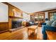 Cozy Gathering room boasting a brick fireplace, wood paneling, and hardwood floors for classic appeal at 4506 Westcliff Ne Trce, Roswell, GA 30075