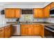 Well-appointed kitchen showcases granite counters, stainless appliances, and wood cabinetry at 4506 Westcliff Ne Trce, Roswell, GA 30075