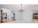 Open-concept living room showcasing an antique grandfather clock and a stairwell at 4506 Westcliff Ne Trce, Roswell, GA 30075
