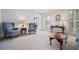 Inviting living room featuring plush carpet, blue upholstered chairs and windows with plantation shutters at 4506 Westcliff Ne Trce, Roswell, GA 30075