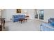 Comfortable living room featuring a blue patterned sofa, plush carpet, and French doors for ample natural light at 4506 Westcliff Ne Trce, Roswell, GA 30075