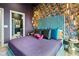 Chic bedroom with a vibrant floral accent wall, plush bedding, and stylish lighting fixtures at 112 Rogers Street Ne # 505, Atlanta, GA 30317