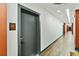Well-lit hallway with wood floors and a door to unit 505, creating an inviting and modern pathway at 112 Rogers Street Ne # 505, Atlanta, GA 30317
