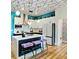 Chic kitchen features white cabinets, a central island with seating, and modern appliances at 112 Rogers Street Ne # 505, Atlanta, GA 30317