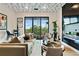 Modern living room boasts a unique ceiling design, comfortable seating, and sliding glass doors to a balcony at 112 Rogers Street Ne # 505, Atlanta, GA 30317