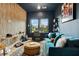 Cozy living room featuring a plush blue sofa, unique decor, and natural light streaming through the windows at 112 Rogers Street Ne # 505, Atlanta, GA 30317