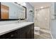 Bathroom features marble countertop vanity and tiled shower with glass doors at 251 Sabrina Ct, Woodstock, GA 30188