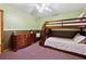 Cozy bedroom featuring a wooden bunk bed, dresser, and carpeted floors at 251 Sabrina Ct, Woodstock, GA 30188