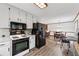 An open kitchen flows into the dining area, featuring black appliances at 251 Sabrina Ct, Woodstock, GA 30188