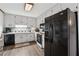Cozy kitchen with white cabinets, black appliances, and wood-look flooring at 251 Sabrina Ct, Woodstock, GA 30188