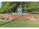 Welcome to Downtown Woodstock sign with colorful design, brick foundation, and lush landscaping at 251 Sabrina Ct, Woodstock, GA 30188
