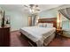 A comfortable main bedroom with soothing color scheme, curtains and ceiling fan at 251 Sabrina Ct, Woodstock, GA 30188