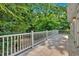 Stone back deck surrounded by greenery offers a tranquil outdoor living space with beautiful natural views at 400 Old Ivy Ne Rd, Atlanta, GA 30342