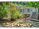 Exterior view of home featuring patio, deck with stairs, and mature trees at 400 Old Ivy Ne Rd, Atlanta, GA 30342