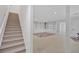 Open basement space with staircase, built in storage, and neutral carpeting at 400 Old Ivy Ne Rd, Atlanta, GA 30342