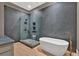 Modern bathroom with a freestanding tub, a glass shower enclosure, and sleek wood floors at 400 Old Ivy Ne Rd, Atlanta, GA 30342