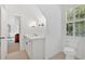 Bright bathroom with modern fixtures, toilet, and view into bedroom at 400 Old Ivy Ne Rd, Atlanta, GA 30342