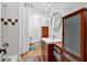 Bathroom featuring a shower with tile accents and custom wood vanity with vessel sink at 400 Old Ivy Ne Rd, Atlanta, GA 30342