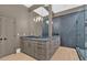 Elegant bathroom with double vanity, stone countertop, and glass-enclosed shower at 400 Old Ivy Ne Rd, Atlanta, GA 30342