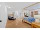 Spacious primary bedroom suite with hard floors, walk out doors, and a seating area at 400 Old Ivy Ne Rd, Atlanta, GA 30342