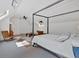 Bright bedroom with dormer windows and seating area with a four-poster bed at 400 Old Ivy Ne Rd, Atlanta, GA 30342