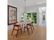 Bright dining room with hardwood floors, views of the surrounding foliage, and modern light fixture at 400 Old Ivy Ne Rd, Atlanta, GA 30342