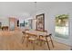 Open dining room with hardwood floors leading to the kitchen and views of the outdoors at 400 Old Ivy Ne Rd, Atlanta, GA 30342