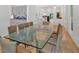 Open dining room features hardwood floors, glass table, and access to the kitchen at 400 Old Ivy Ne Rd, Atlanta, GA 30342