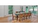 Dining room with hardwood floors, multiple windows with wooded views, and seating for ten at 400 Old Ivy Ne Rd, Atlanta, GA 30342