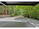 Long driveway approaching the house passes through lush, mature landscaping at 400 Old Ivy Ne Rd, Atlanta, GA 30342