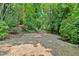 Long driveway approaching the house passes through lush, mature landscaping at 400 Old Ivy Ne Rd, Atlanta, GA 30342