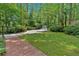 Long driveway approaching the house passes through lush, mature landscaping at 400 Old Ivy Ne Rd, Atlanta, GA 30342