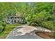 A long driveway leads to a stately home surrounded by mature trees and landscaping at 400 Old Ivy Ne Rd, Atlanta, GA 30342