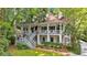 Charming two-story white home featuring double porches and lush green landscaping at 400 Old Ivy Ne Rd, Atlanta, GA 30342